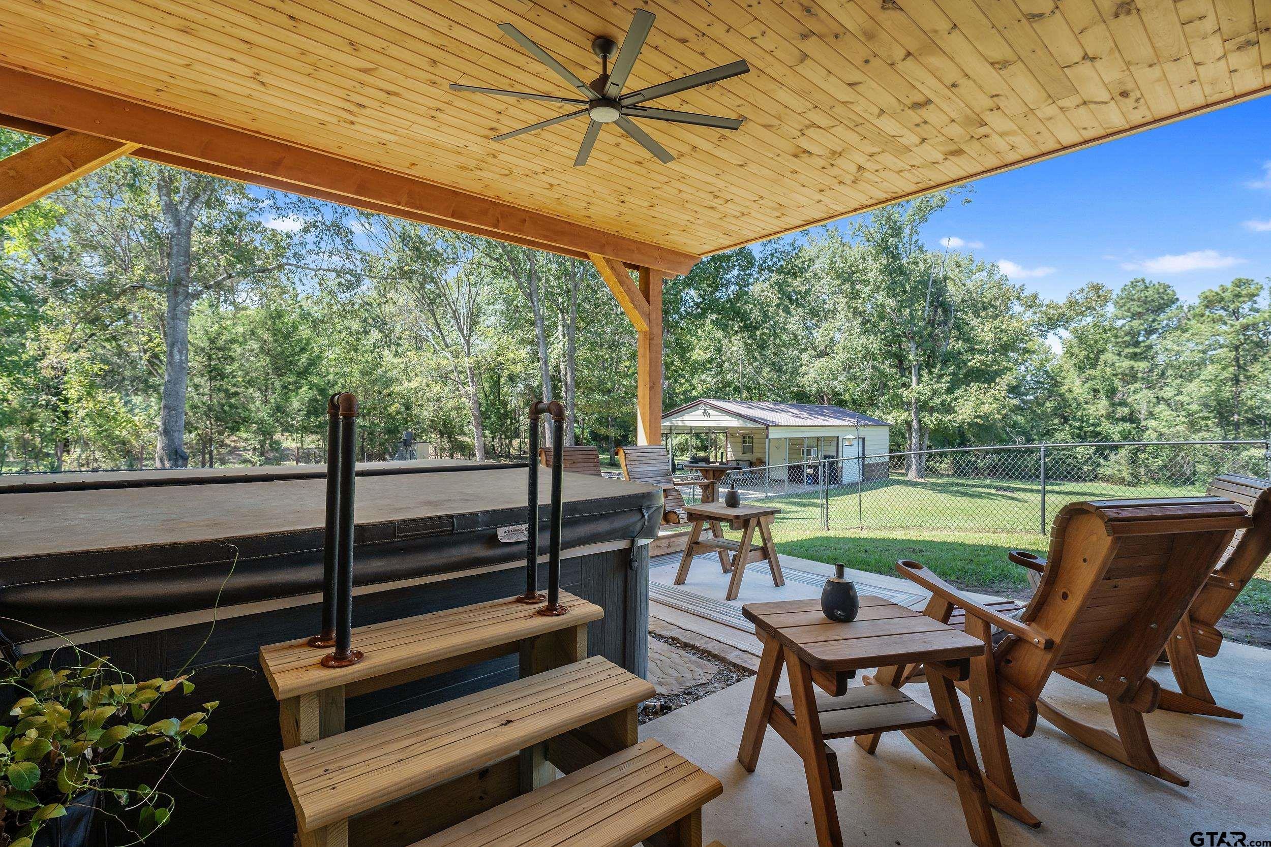 140 Creek Drive Marshall, TX 75672 - Photo 25 of 35 a view of a swimming pool with a table and chairs under an umbrella