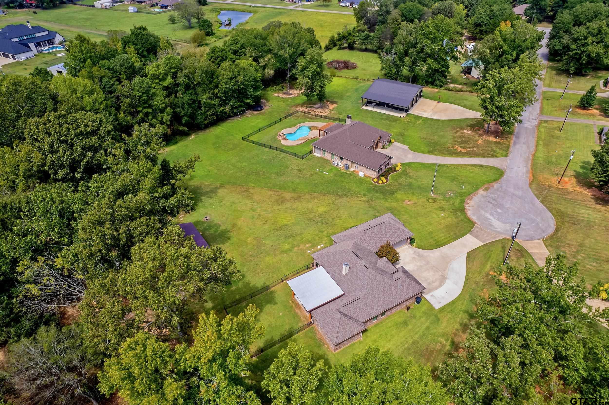 140 Creek Drive Marshall, TX 75672 - Photo 34 of 35 an aerial view of a house with a garden