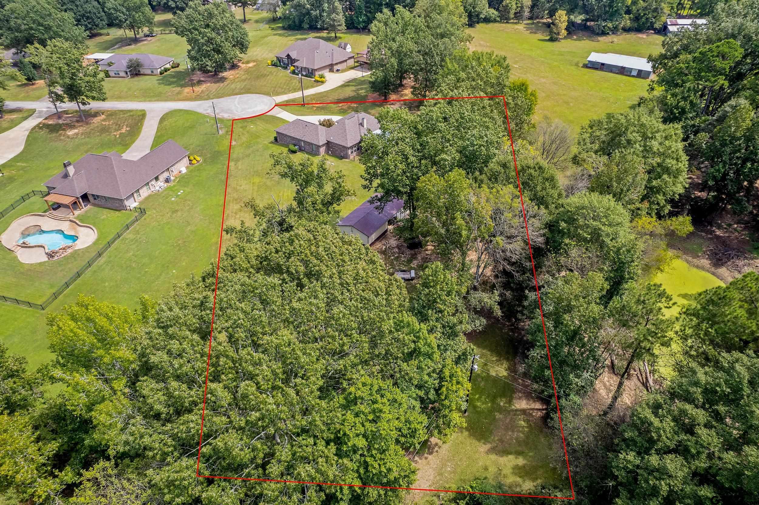 140 Creek Drive Marshall, TX 75672 - Photo 35 of 35 an aerial view of residential houses with outdoor space and trees all around