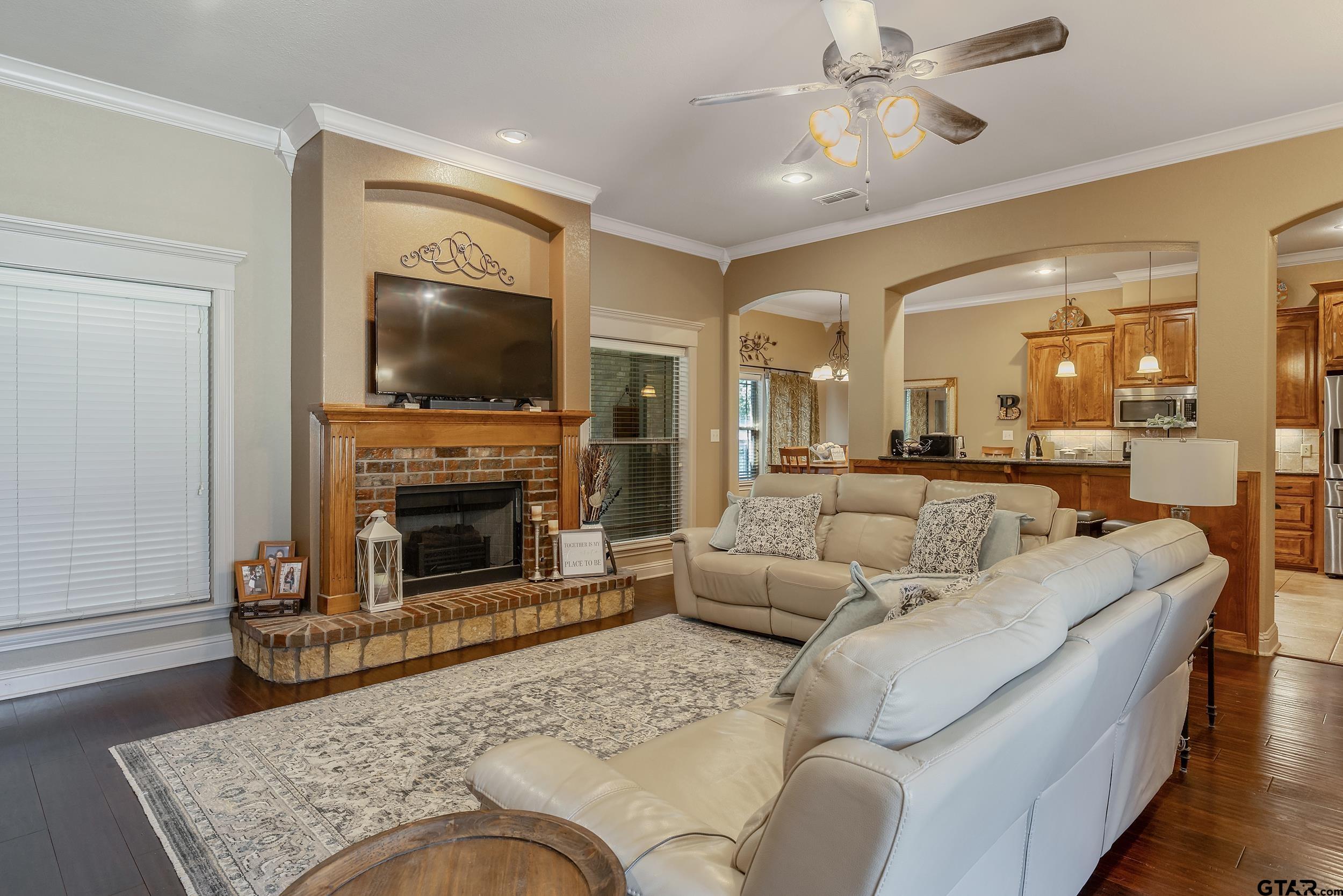 140 Creek Drive Marshall, TX 75672 - Photo 5 of 35 a living room with furniture a flat screen tv and a fireplace