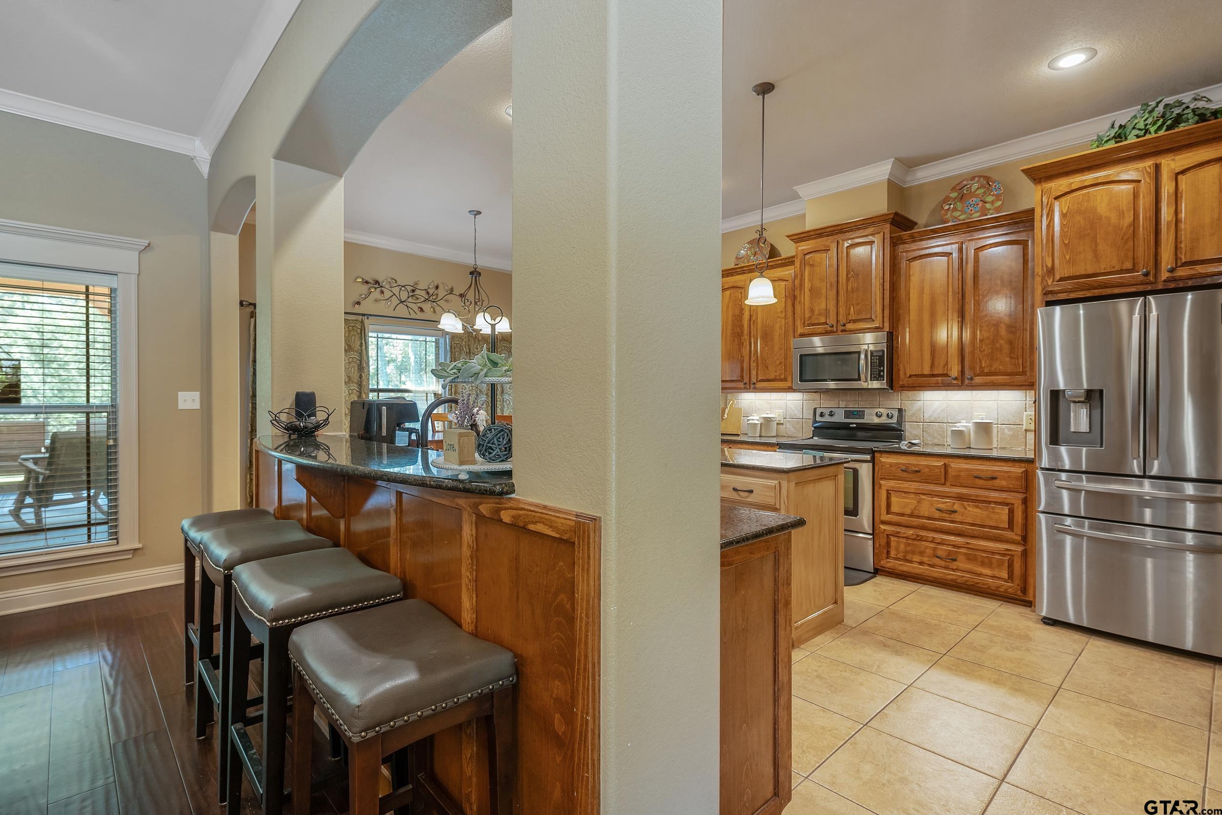 140 Creek Drive Marshall, TX 75672 - Photo 7 of 35 a kitchen with a refrigerator a stove and a dining table