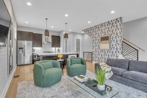 a living room with fireplace furniture and a table