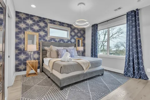 a bedroom with a bed and a mirror