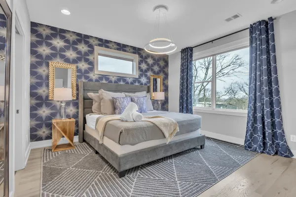 a bedroom with a bed and a mirror