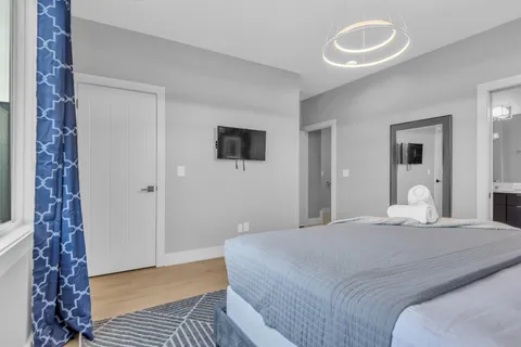 a bed sitting in a bedroom next to a window