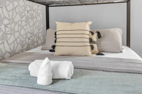 a bedroom with double bed and a large window