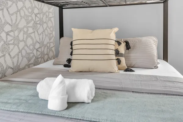 a bedroom with double bed and a large window