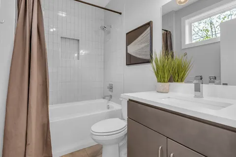 a bed with white sheets and pillows on it