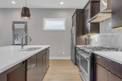 a kitchen with a sink stove and cabinets
