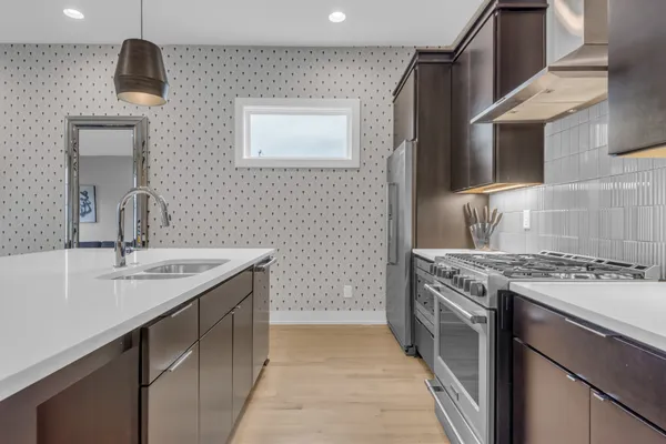 a kitchen with a sink stove and cabinets