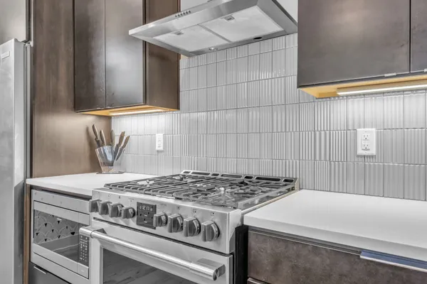 a stove top oven sitting inside of a kitchen