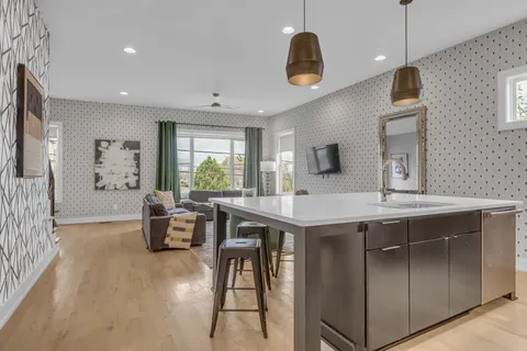 a kitchen with a table chairs sink and microwave