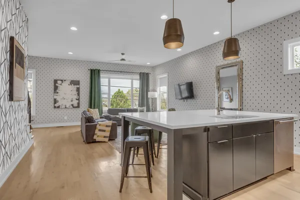 a kitchen with a table chairs sink and microwave