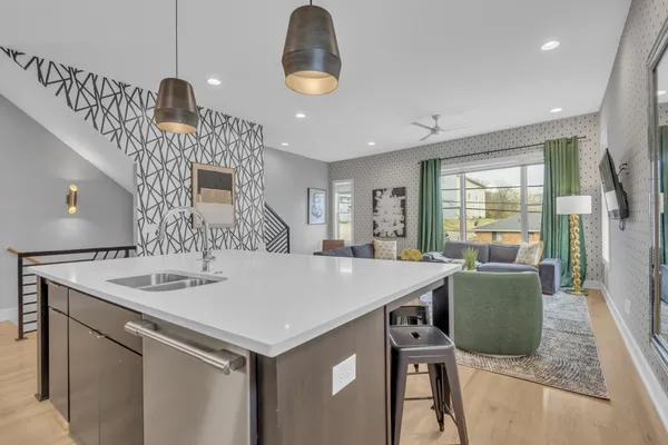 a kitchen with a table a refrigerator a sink and a stove
