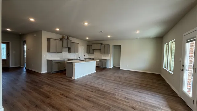 a kitchen with a sink cabinets and wooden floor