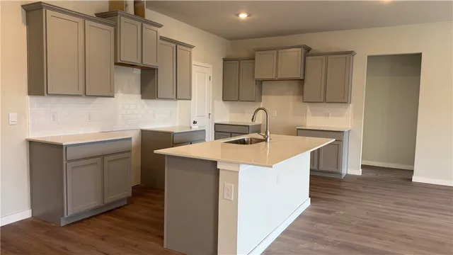 a view of a kitchen with a sink and wooden floor
