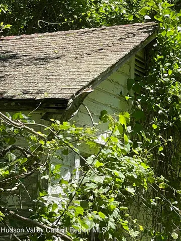 a backyard of a house with lots of green space and wooden fence