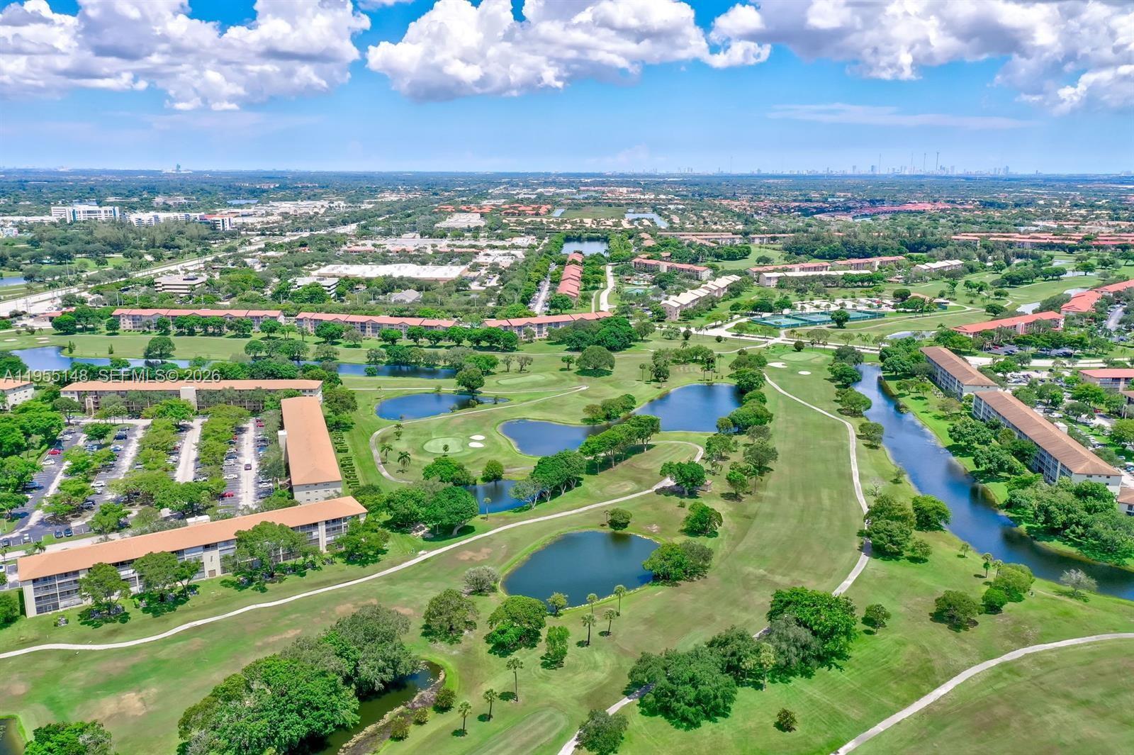 200 Southwest 132nd Way, Unit 109L Pembroke Pines, FL 33027 - Photo 15 of 18 an aerial view of lake residential houses with outdoor space and swimming pool