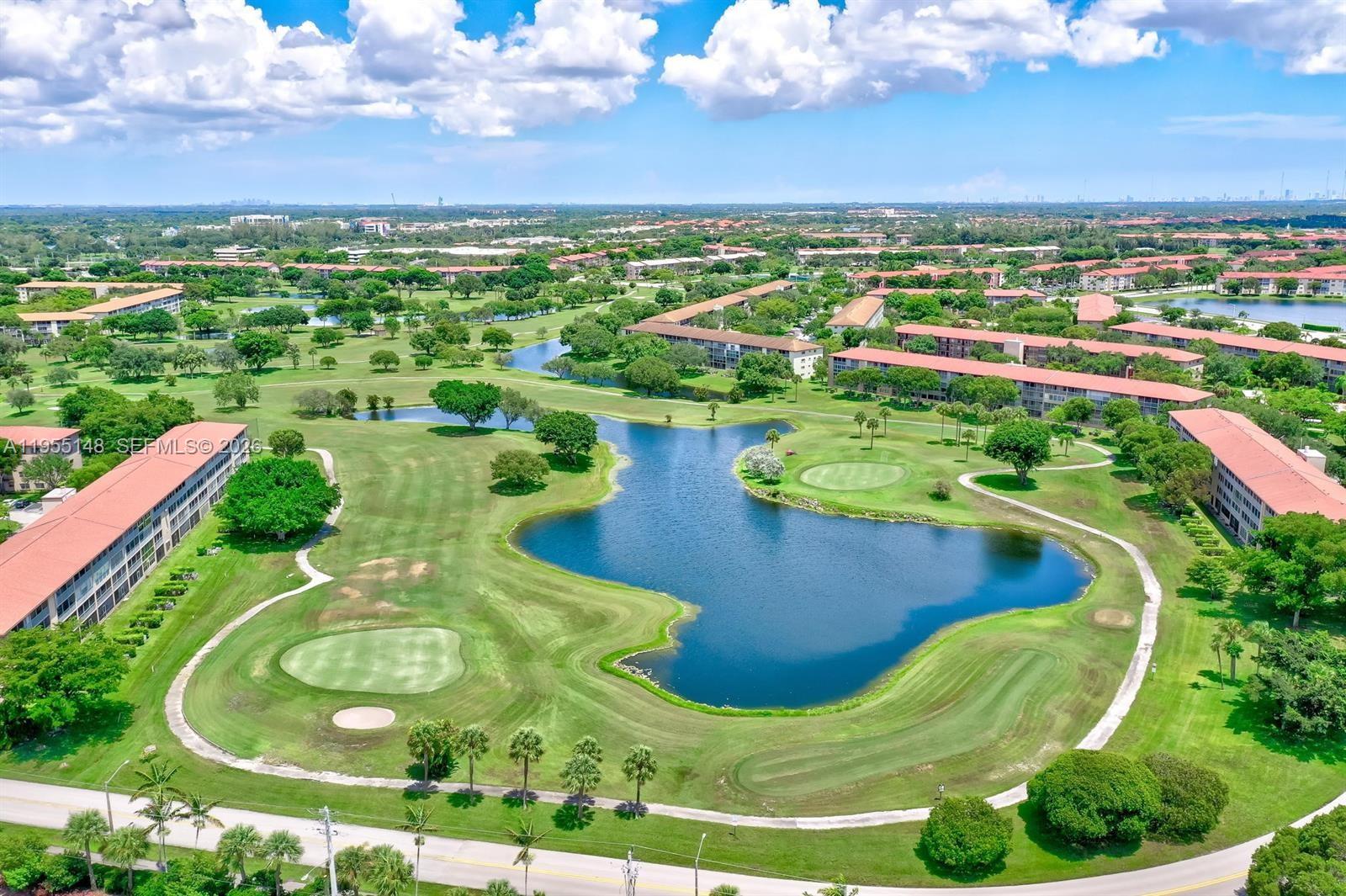 200 Southwest 132nd Way, Unit 109L Pembroke Pines, FL 33027 - Photo 17 of 18 a view of a swimming pool with a garden