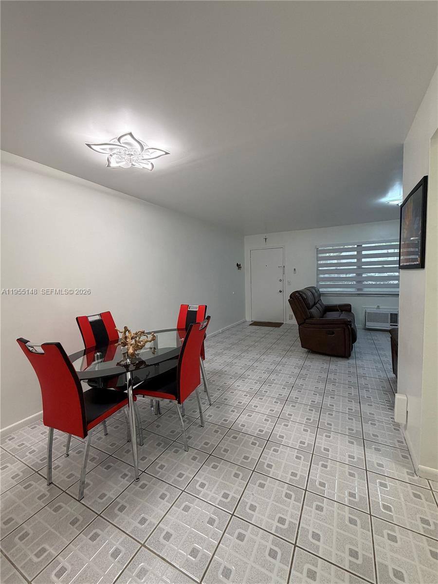 200 Southwest 132nd Way, Unit 109L Pembroke Pines, FL 33027 - Photo 7 of 18 a living room with furniture and a chandelier