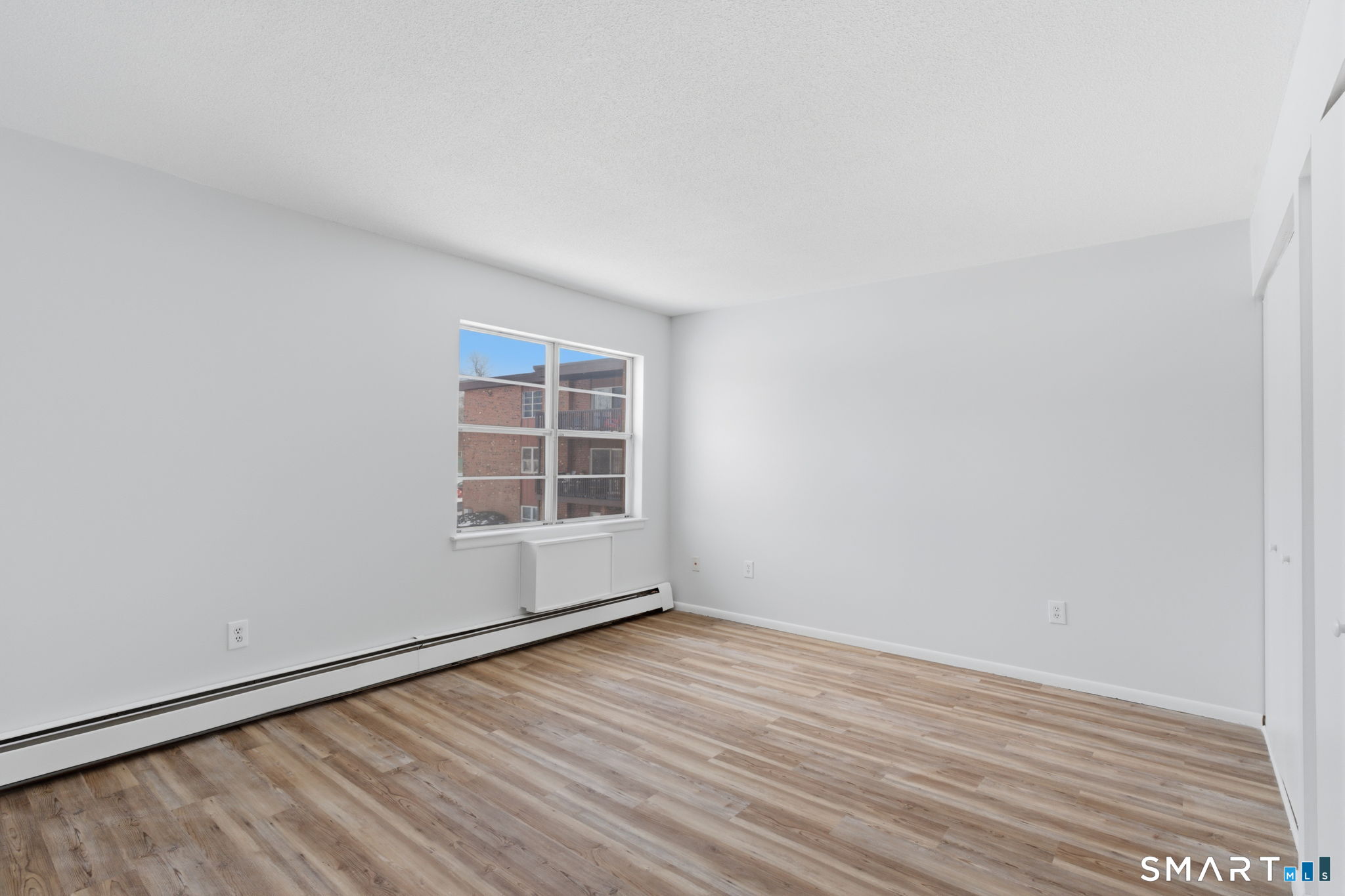 75 Balance Rock Road, Unit 20 Seymour, CT 06483 - Photo 13 of 80 a view of an empty room with wooden floor and windows