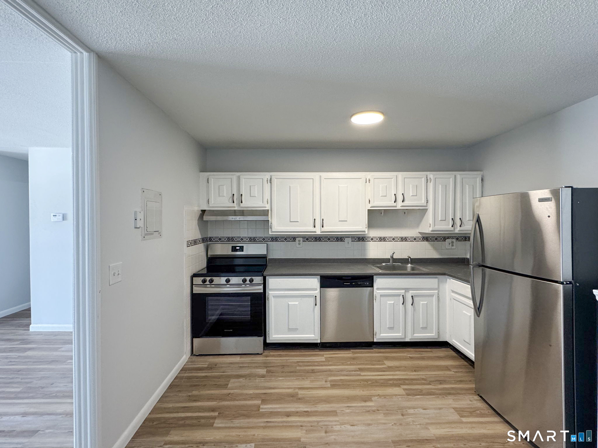 75 Balance Rock Road, Unit 20 Seymour, CT 06483 - Photo 37 of 80 a kitchen with granite countertop a refrigerator and a stove top oven