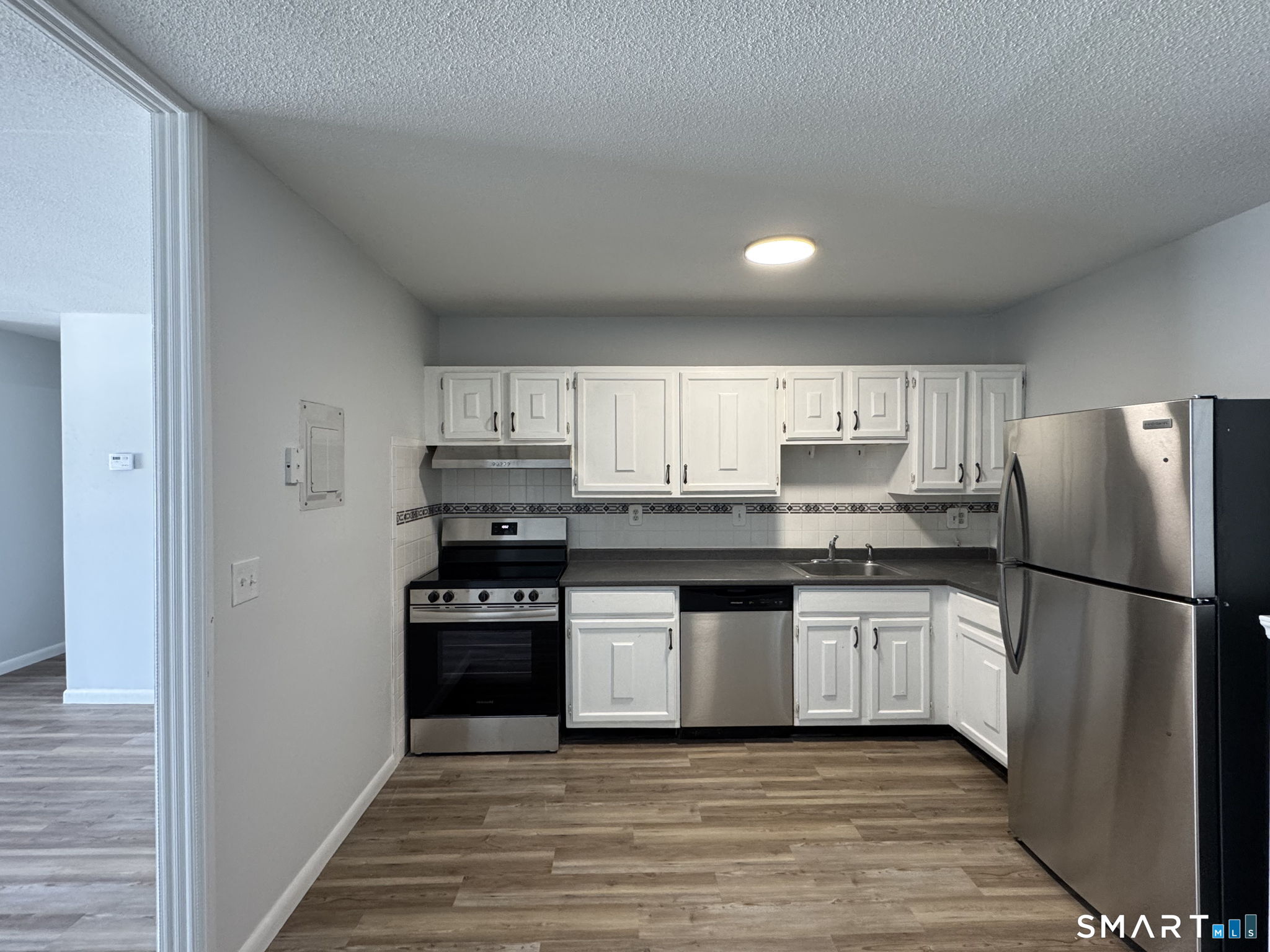 75 Balance Rock Road, Unit 20 Seymour, CT 06483 - Photo 38 of 80 a kitchen with granite countertop a refrigerator and a stove top oven