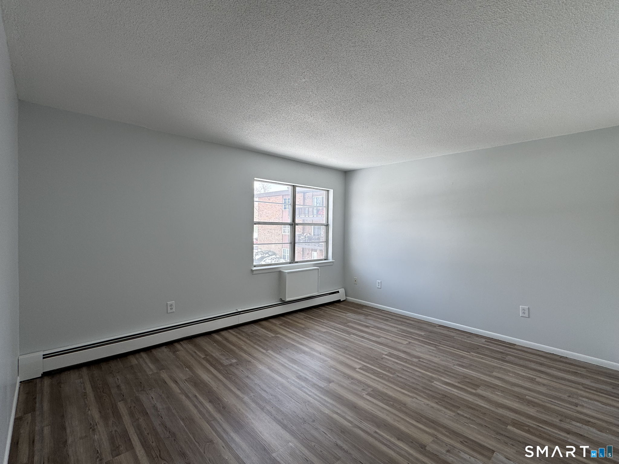 75 Balance Rock Road, Unit 20 Seymour, CT 06483 - Photo 57 of 80 a view of an empty room with wooden floor and a window