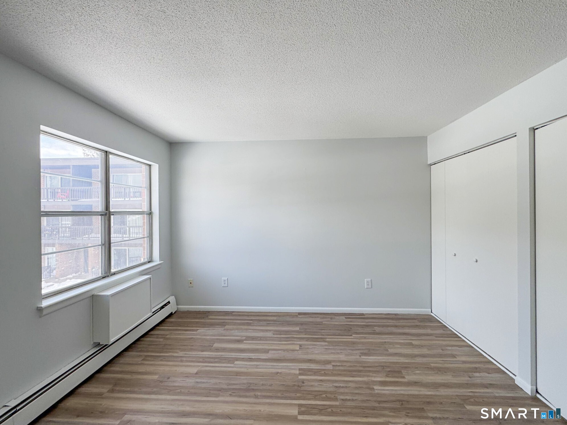 75 Balance Rock Road, Unit 20 Seymour, CT 06483 - Photo 64 of 80 wooden floor in an empty room with a window