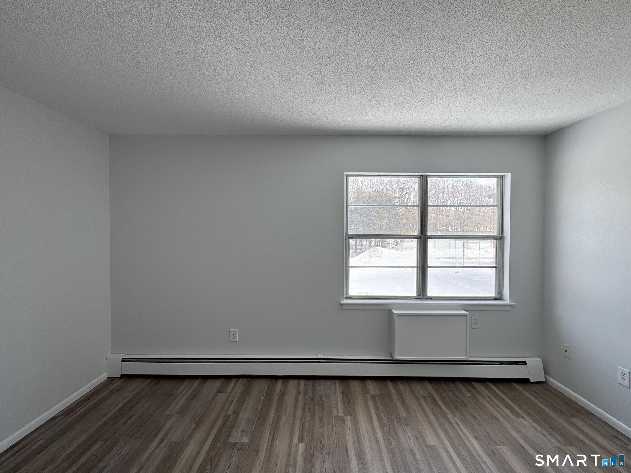 75 Balance Rock Road, Unit 20 Seymour, CT 06483 - Photo 78 of 80 an empty room with wooden floor and windows