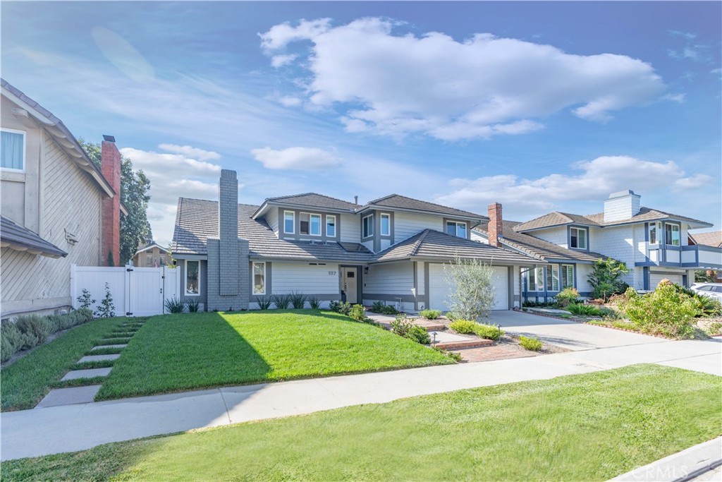 a front view of a house with a yard table and chairs