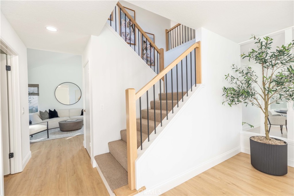 1117 Dennis Drive Costa Mesa, CA 92626 - Photo 14 of 44 a view of entryway livingroom and hall with wooden floor