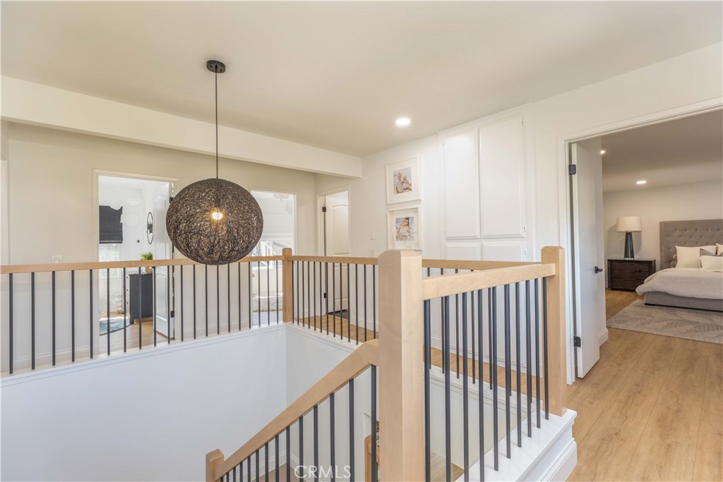 1117 Dennis Drive Costa Mesa, CA 92626 - Photo 15 of 44 a view of a hallway with a chandelier