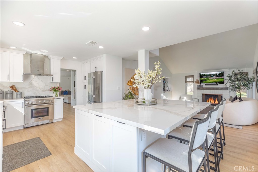 1117 Dennis Drive Costa Mesa, CA 92626 - Photo 2 of 44 a kitchen with kitchen island a stove a table and chairs in it