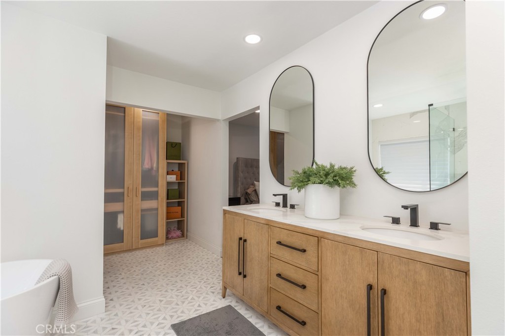 1117 Dennis Drive Costa Mesa, CA 92626 - Photo 22 of 44 a bathroom with a double vanity sink and a mirror