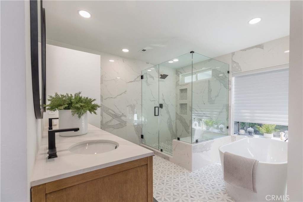 1117 Dennis Drive Costa Mesa, CA 92626 - Photo 23 of 44 a bathroom with a granite countertop sink a toilet a large mirror and shower