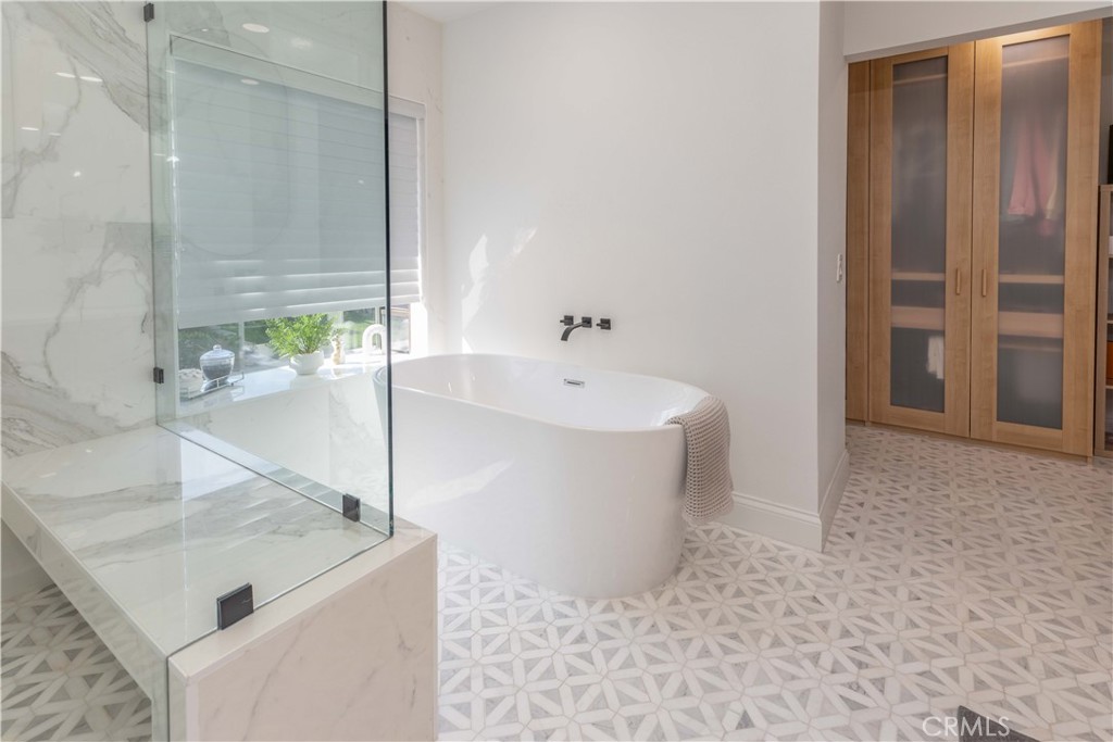 1117 Dennis Drive Costa Mesa, CA 92626 - Photo 24 of 44 a white bath tub sitting in a bathroom and sink