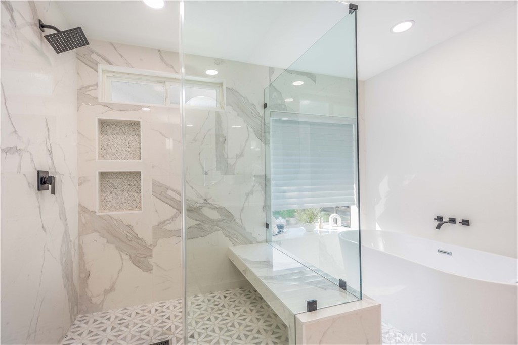 1117 Dennis Drive Costa Mesa, CA 92626 - Photo 26 of 44 a bathroom with a granite countertop sink a mirror and shower