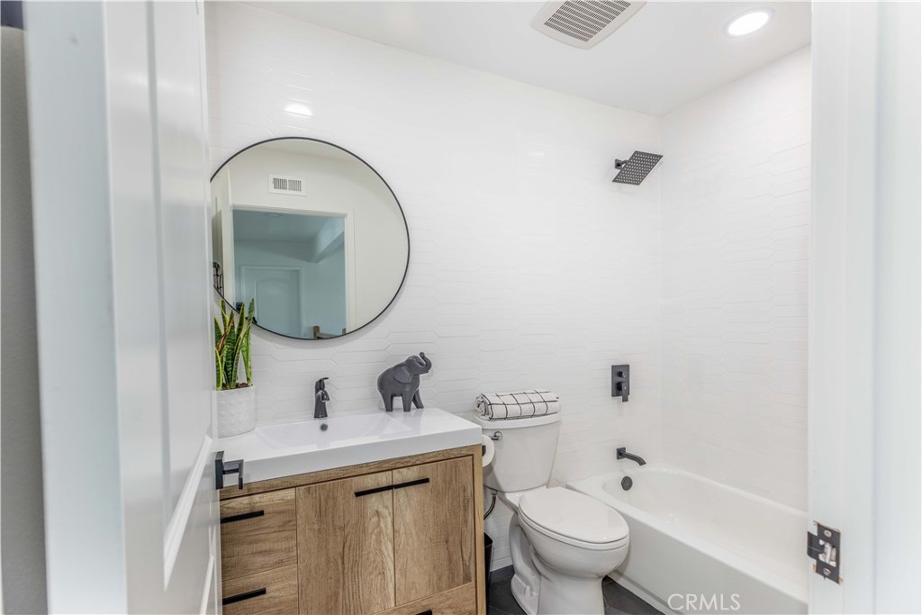 1117 Dennis Drive Costa Mesa, CA 92626 - Photo 27 of 44 a bathroom with a toilet sink and mirror