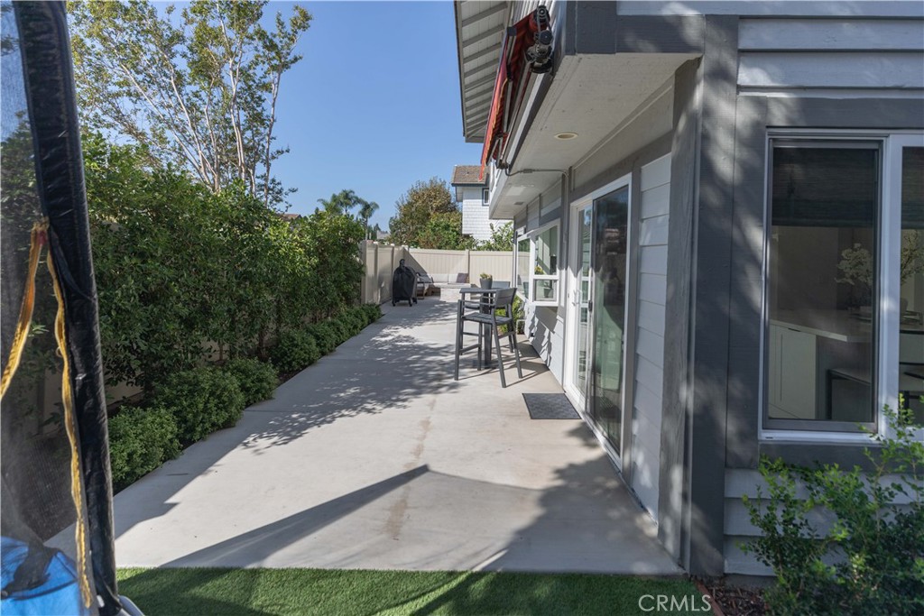 1117 Dennis Drive Costa Mesa, CA 92626 - Photo 35 of 44 a view of a patio with table and chairs potted plants with wooden floor and fence