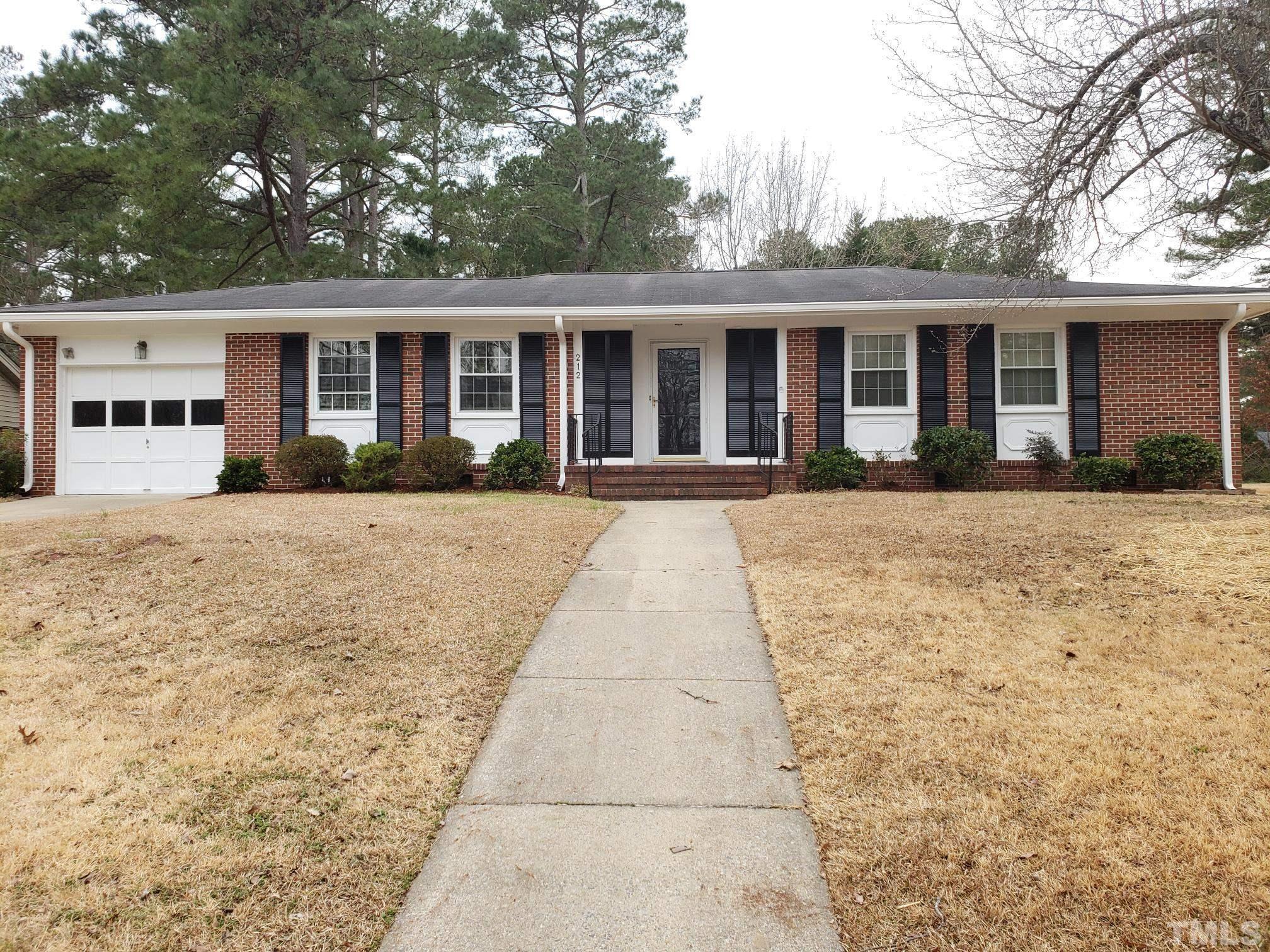 212 Longview Drive Smithfield, NC 27577 - Photo 1 of 21 front view of a brick house with a yard
