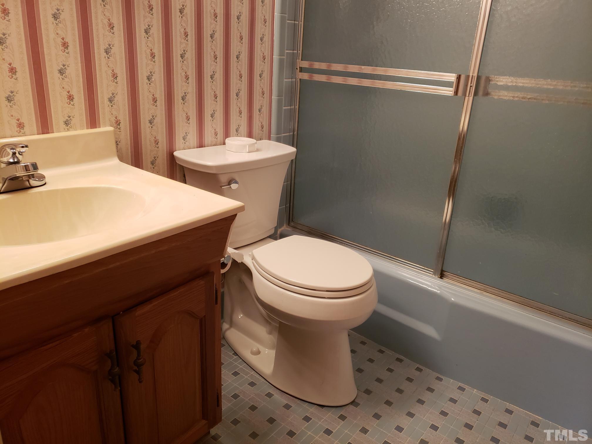 212 Longview Drive Smithfield, NC 27577 - Photo 11 of 21 a bathroom with a sink a toilet and shower
