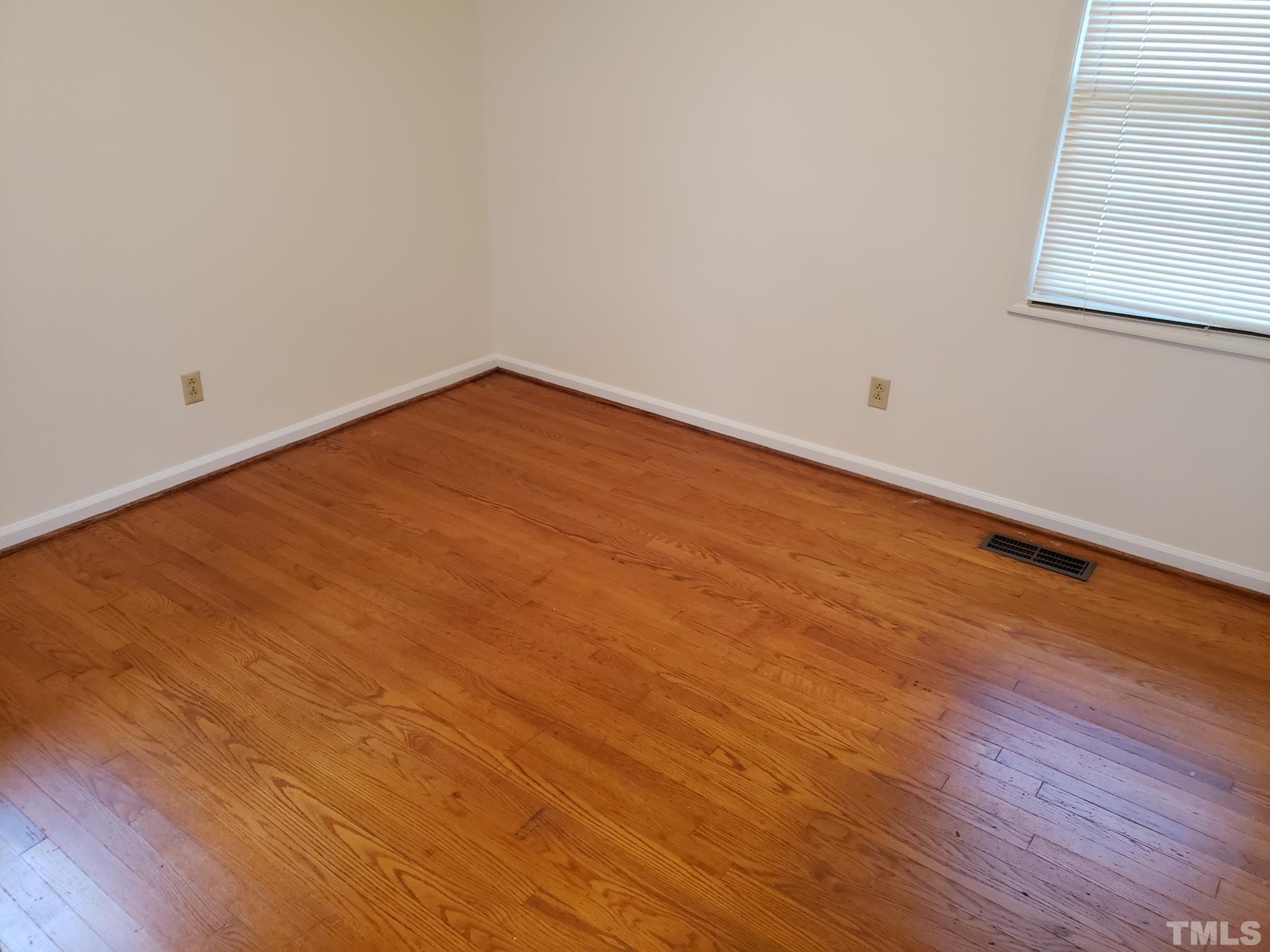 212 Longview Drive Smithfield, NC 27577 - Photo 13 of 21 an empty room with wooden floor and windows