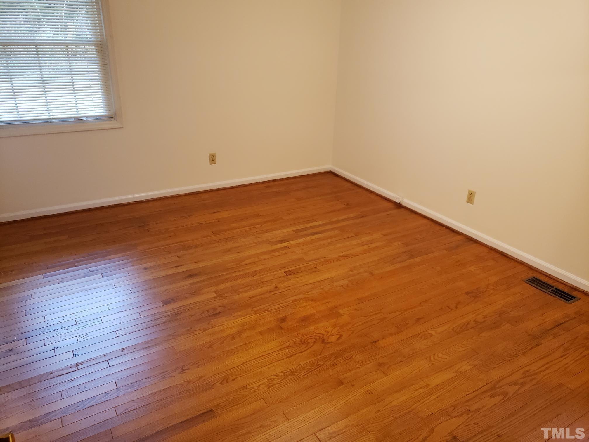 212 Longview Drive Smithfield, NC 27577 - Photo 14 of 21 an empty room with wooden floor and windows