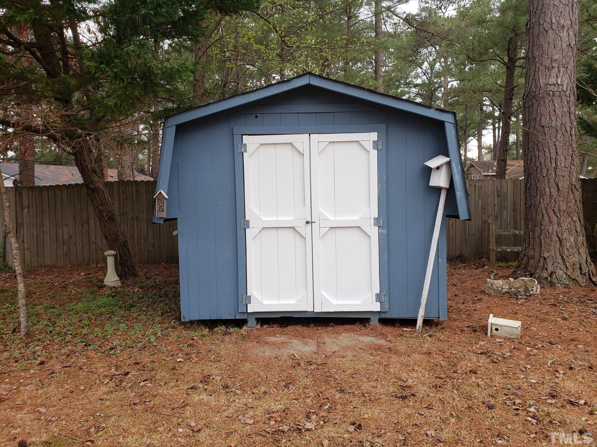 212 Longview Drive Smithfield, NC 27577 - Photo 20 of 21 a wooden house with a yard and large tree
