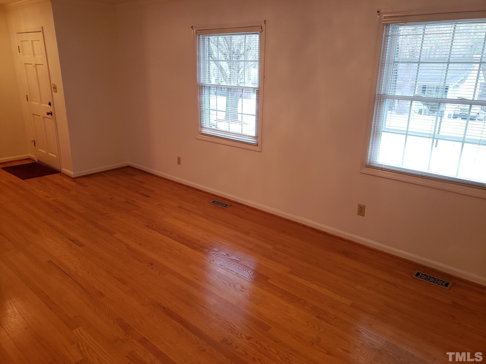 212 Longview Drive Smithfield, NC 27577 - Photo 3 of 21 an empty room with wooden floor and windows