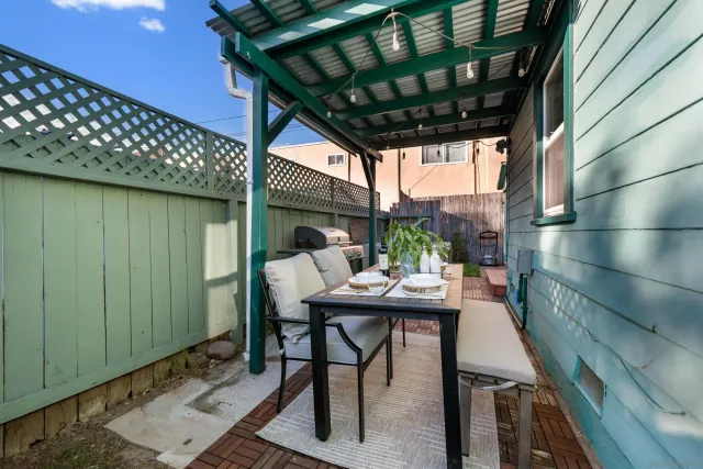 a view of backyard with a table and chairs