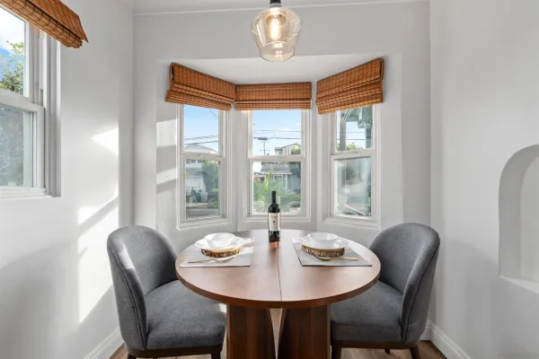 a dining room with furniture and window