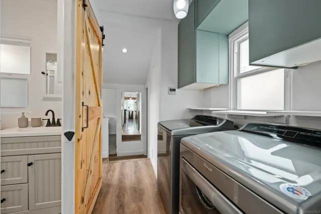 a kitchen with a sink stove and cabinets