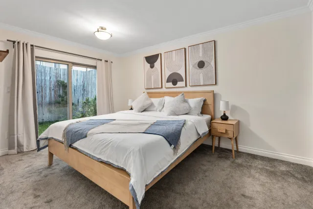 a bedroom with a bed and glass window